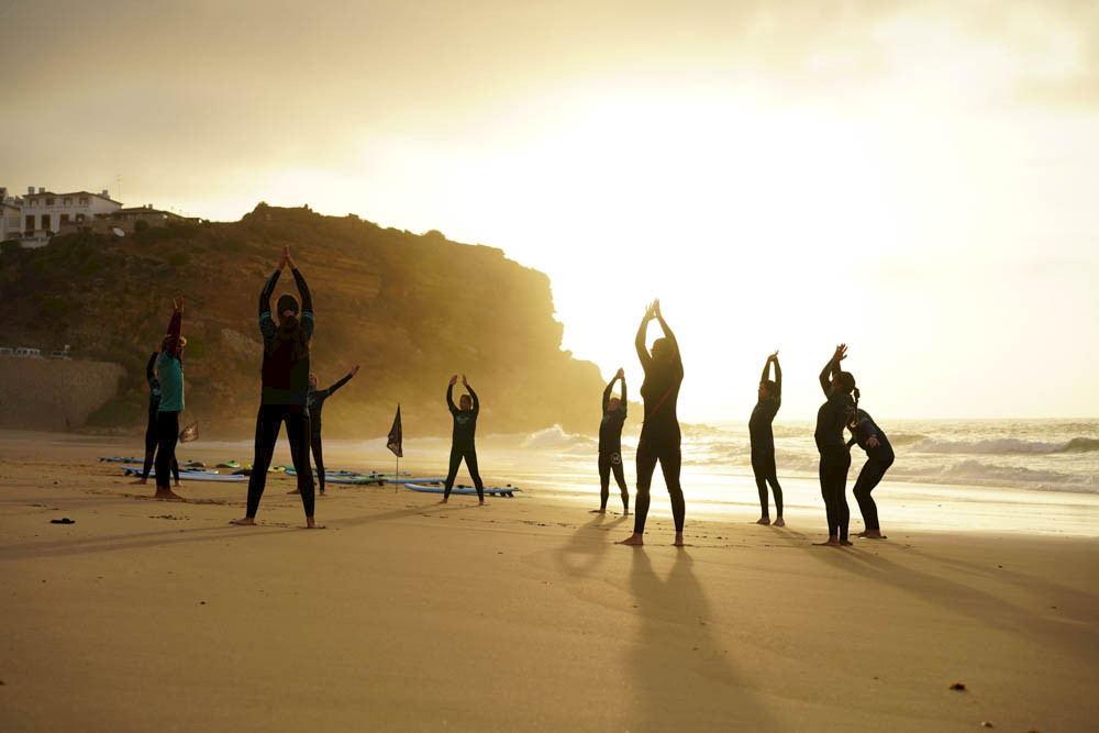 a group of people standing on a beach