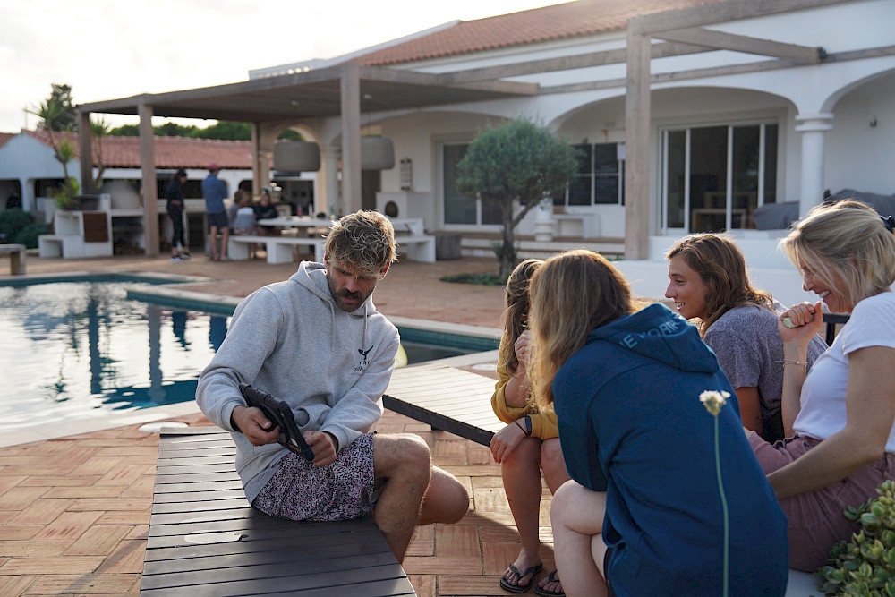 a group of people sitting around a pool