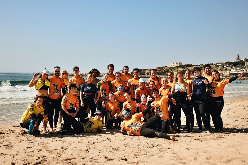 group lesson for surfers on a beach