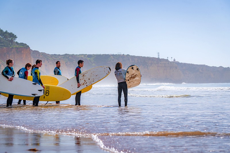 A surf lesson group about to hit the waves