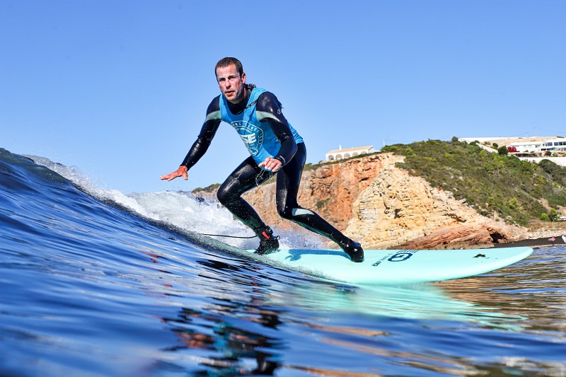 A guy surfing a wave in the Algarve