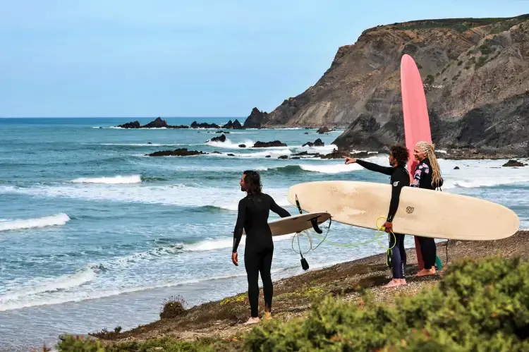 Surfers heading out into the ocean